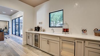 A kitchen with a white counter top and a window.